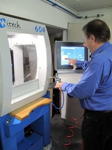 Paul is cleaning off a recently made part. The benefit of this machine over the older machine (which was on the other side of the garage) which he used to make my watches - is that this machine can change tools - and so do more work in one session and avoid the registration errors from changing and re-mounting parts being made. Paul is clearly an enthusiast for these machines.