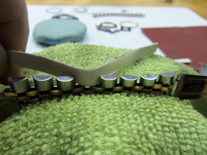 Strips of sand paper, too refinish the links.