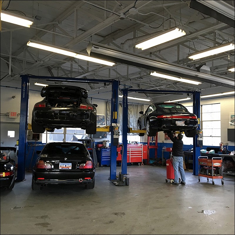 Oil getting drained. What's that BMW doing in here???