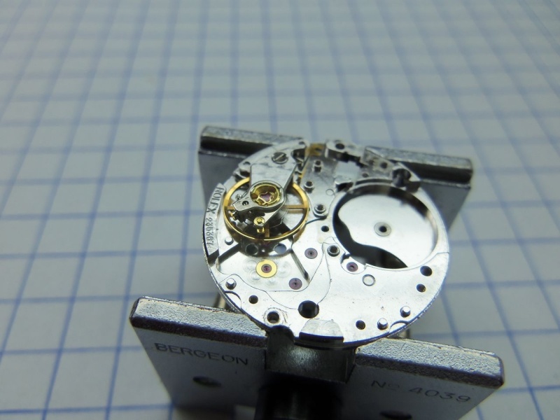 Placing the balance assembly back into the movement for cleaning.