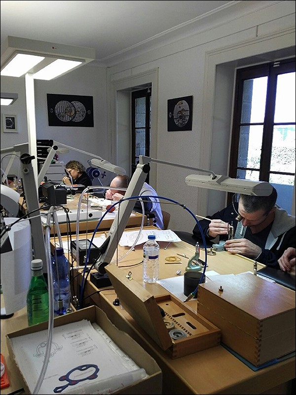 5 watchmakers and a polisher at the benches on this day. Each watchmaker constructs a complete watch including case and dial. 