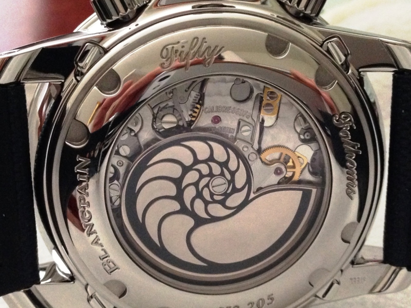In this photo of the sapphire exhibition caseback on my watch, you can see the under-lug adjustments as well as Blancpains classic vertical clutch column-wheel controlled flyback movement