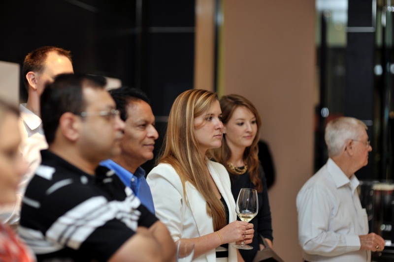 Guests listening attentively to the watchmaker