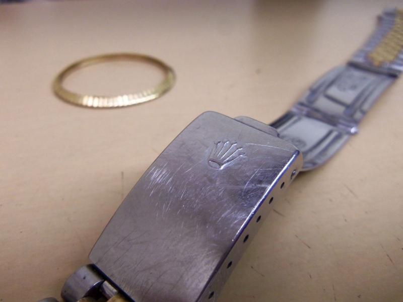 Taking care not to polish holes on clasp and case lugs.