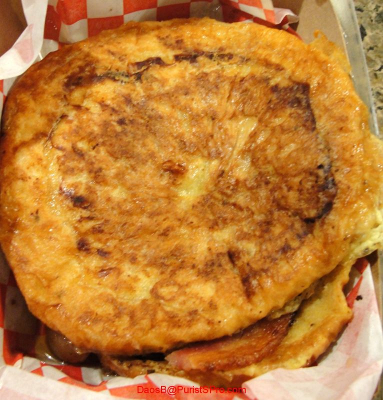 French toast sandwich with bacon and syrup inside.