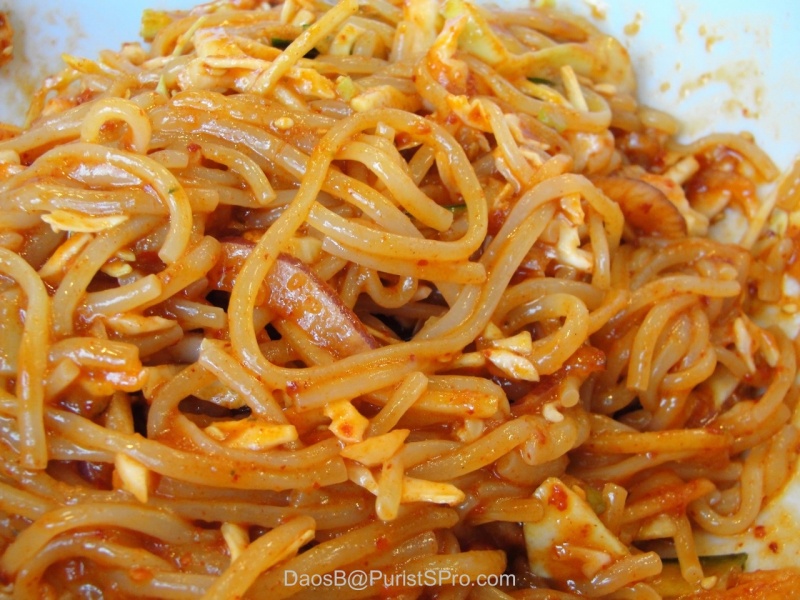 The chewy noodles after being tossed.