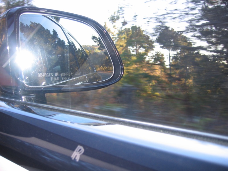 The scenery passes by, the car is quiet, almost eerily quiet. 