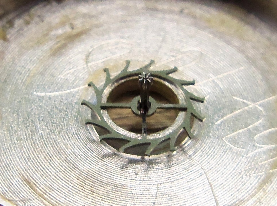 Holding escape wheel in this way, allows good access to the teeth for application.